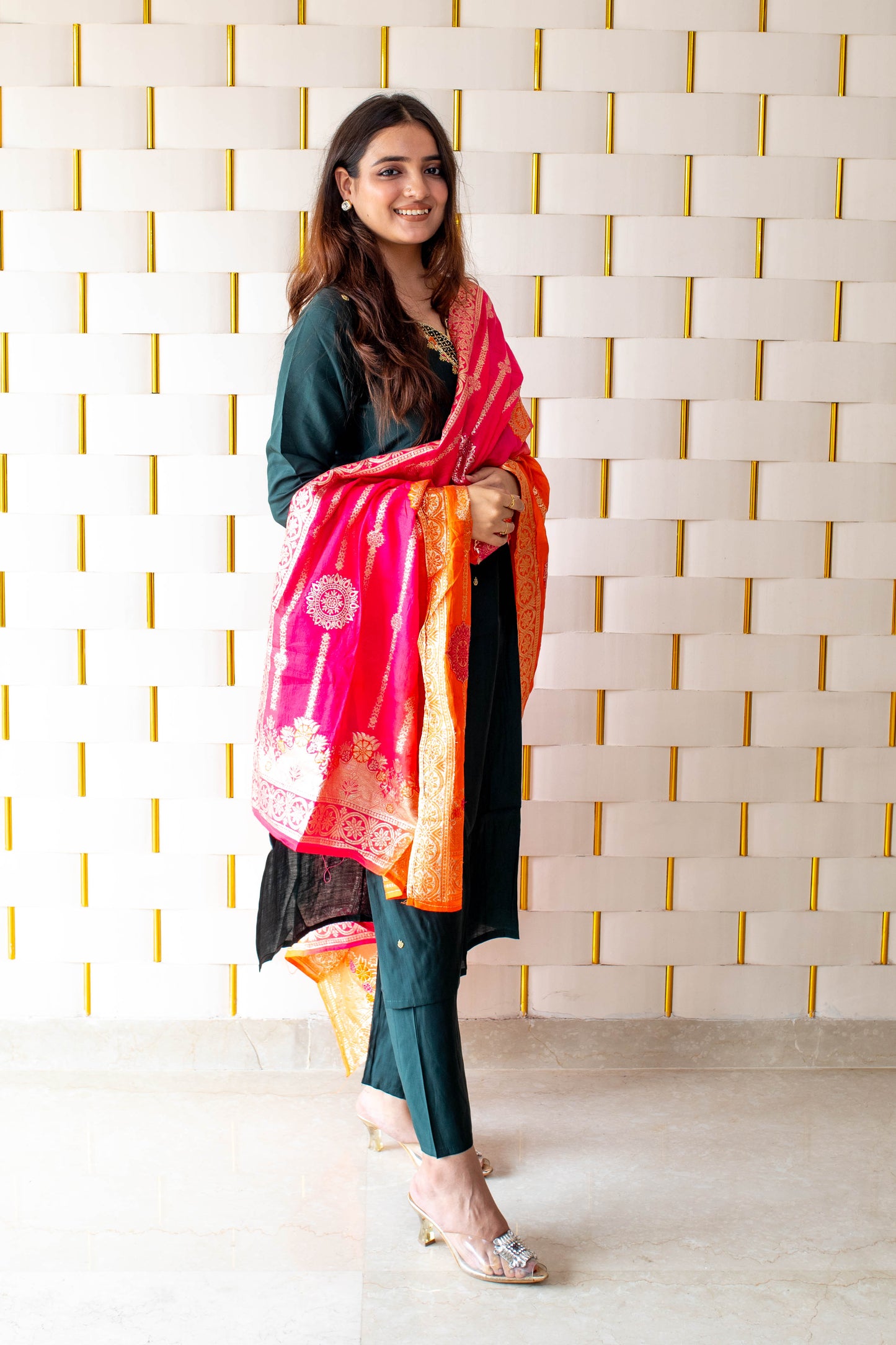 Green Suit paired with a vibrant Silky Orange Dupatta