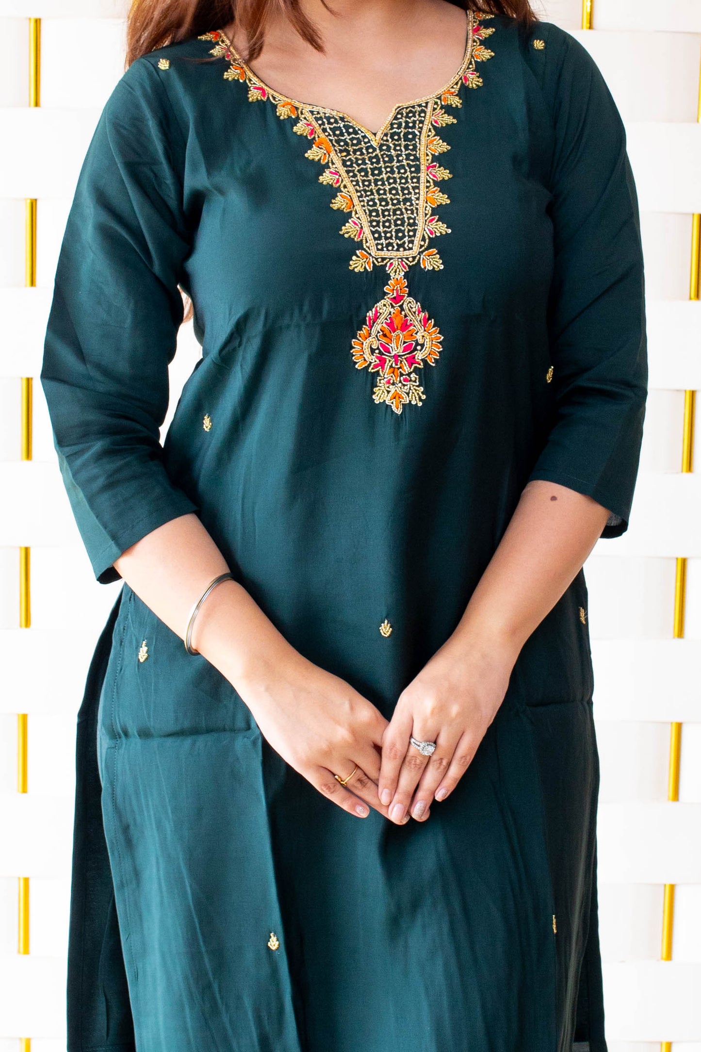 Green Suit paired with a vibrant Silky Orange Dupatta